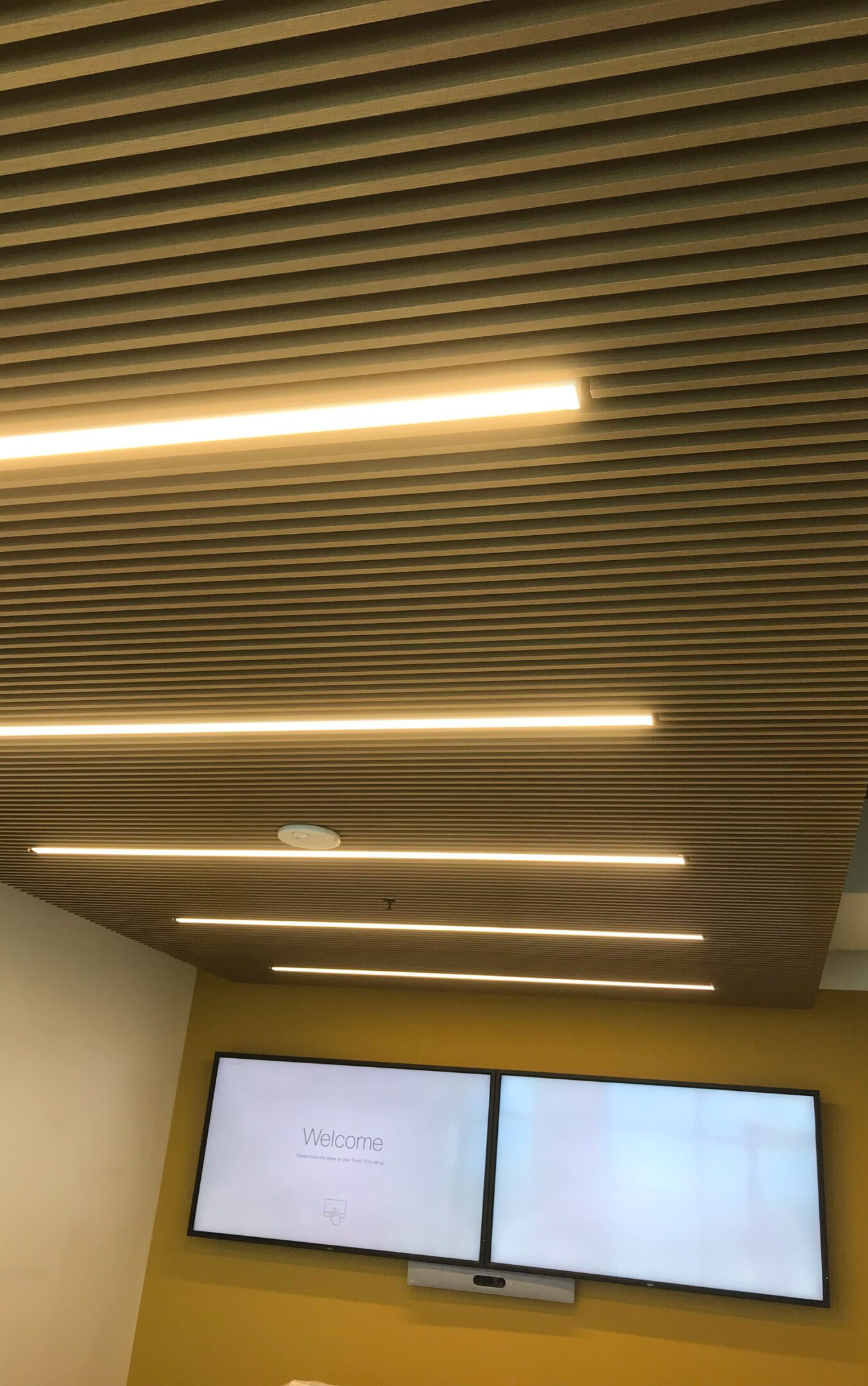 Yellow wall with mounted screens